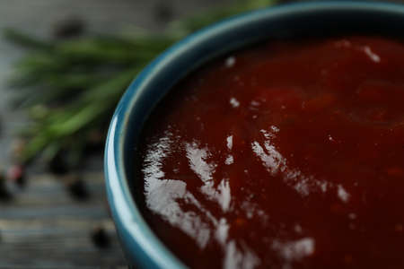 Bowl of barbecue sauce and spices on wooden backgroundの写真素材