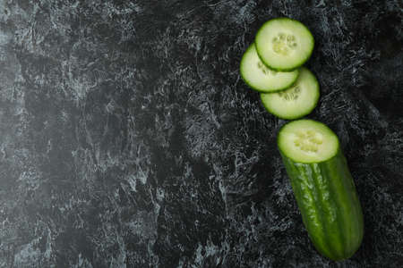 Ripe cucumber and slices on black smoky backgroundの写真素材