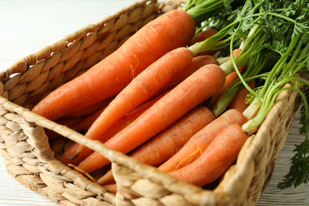 Basket with fresh ripe carrot, close upの写真素材