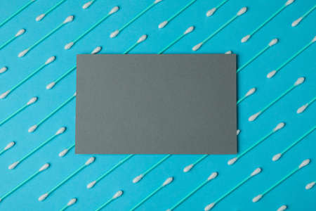 Flat lay with cotton swabs on blue background, space for textの写真素材