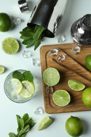 Glass of fresh mojito cocktail and ingredients on white backgroundの写真素材