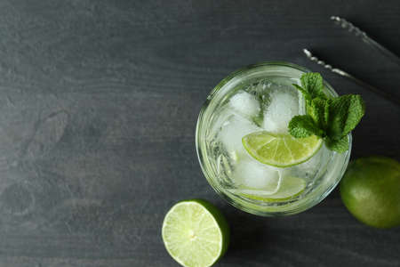 Glass of mojito cocktail and ingredient on dark wooden tableの写真素材