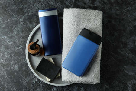 Concept of men's hygiene tools on black smokey table