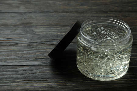 Jar of styling gel on wooden tableの写真素材