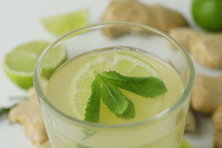 Glass of ginger beer and ingredients, close up