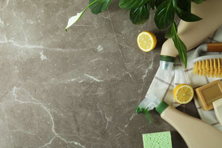 Cleaning concept with eco friendly cleaning tools on gray textured table