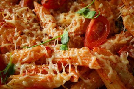 Delicious pasta with tomato sauce and cheese, close upの写真素材