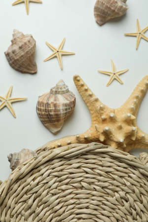 Straw bag and seashells on white backgroundの写真素材