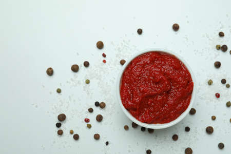 Bowl with tomato paste, pepper and salt on white backgroundの写真素材