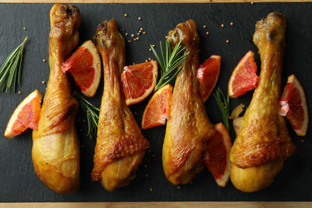 Board with roast chicken drumsticks, top viewの写真素材