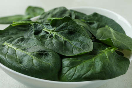 Bowl of fresh raw spinach, close upの写真素材