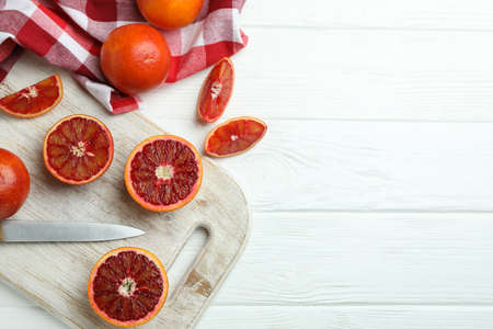 Concept of citrus with red oranges on white wooden table