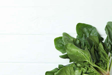 Fresh raw spinach on white wooden backgroundの写真素材