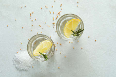 Shots of tequila on white textured table