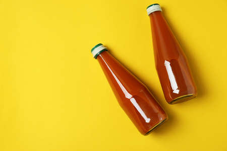Bottles of carrot juice on yellow backgroundの写真素材