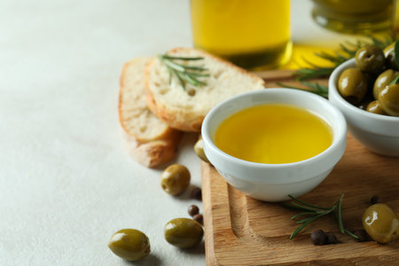 Concept of tasty eating with olive oil on white textured backgroundの写真素材