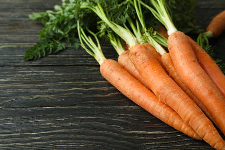 Heap of fresh carrot on wooden backgroundの写真素材