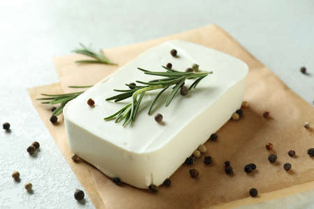 Baking paper with feta, pepper and rosemary on white textured backgroundの写真素材