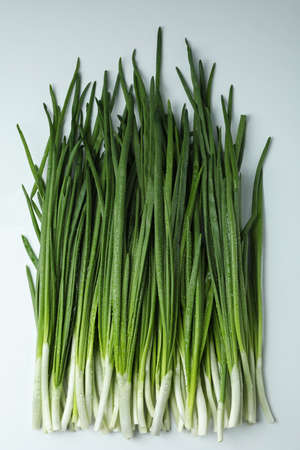 Fresh green onion with water drops on white background