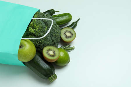 Paper bag with green vegetables on white backgroundの写真素材