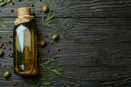 Bottle of olive oil and spices on wooden backgroundの写真素材
