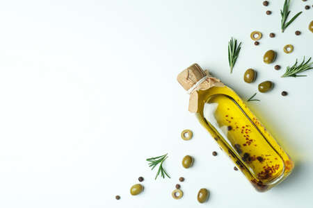 Bottle of olive oil, olives and spices on white backgroundの写真素材