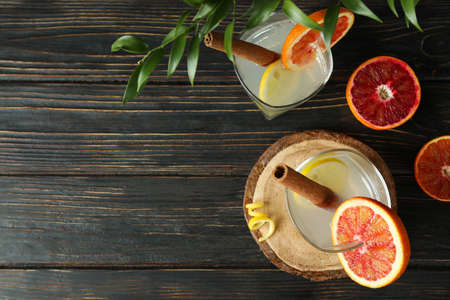 Glasses of cocktail with citrus on wooden backgroundの写真素材