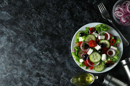 Concept of delicious food with Greek salad on black smokey backgroundの写真素材