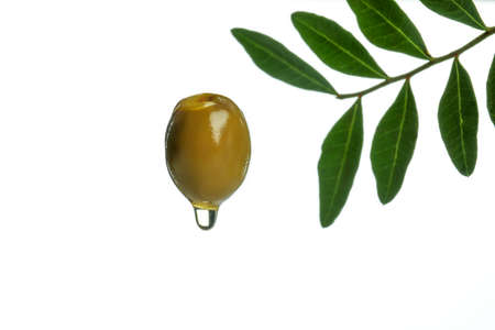 Green olive with oil isolated on white backgroundの写真素材