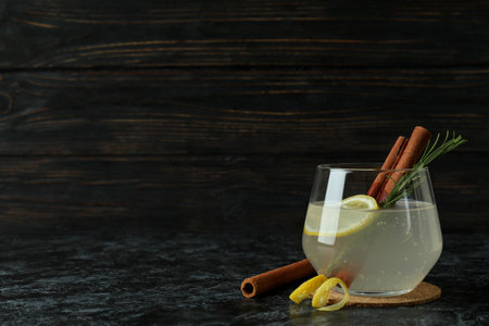 Glass of lemonade with cinnamon and rosemary on black smokey tableの写真素材