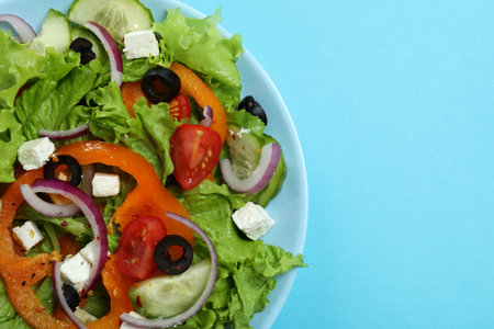 Plate of greek salad on blue background, close upの写真素材