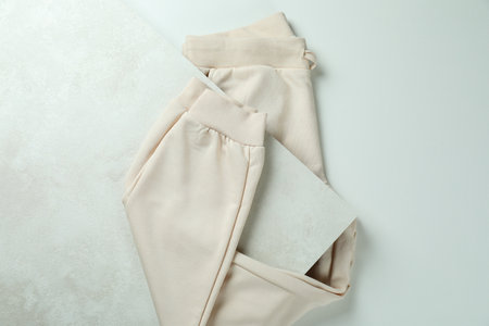 Folded sweatpants on white textured background, top viewの写真素材