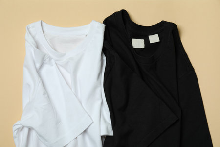 Black and white t-shirts on beige backgroundの写真素材