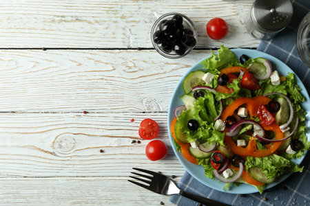 Concept of tasty eating with Greek salad on white wooden tableの写真素材