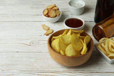 Different snacks, beer and sauces on white wooden backgroundの写真素材