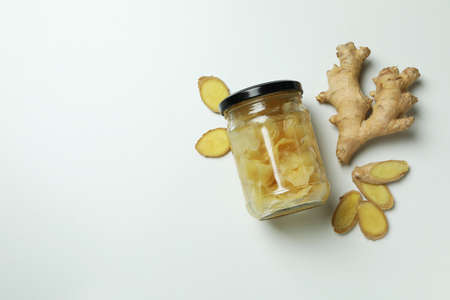 Jar with pickled ginger and ginger on white backgroundの写真素材
