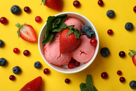 Fruit ice cream and ingredients on yellow backgroundの写真素材
