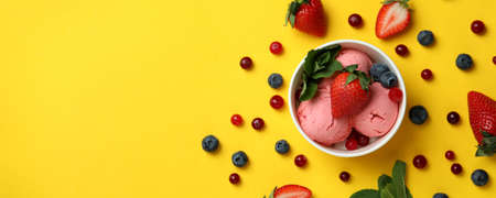Fruit ice cream and ingredients on yellow background