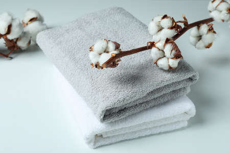Cotton plant branches and towels on white backgroundの写真素材
