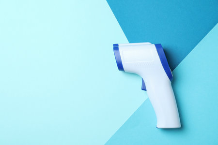 Thermometer gun on three tone background, space for textの写真素材
