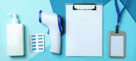 Medical tools and thermometer gun on three tone background