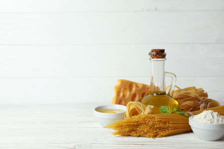 Concept of cooking tasty pasta on white wooden backgroundの写真素材