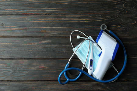 Medical concept with thermometer gun on wooden backgroundの写真素材