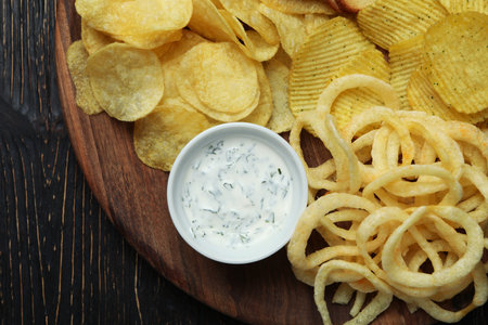 Tray with different snacks on wooden backgroundの写真素材