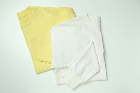 White and yellow sweatshirts on white background