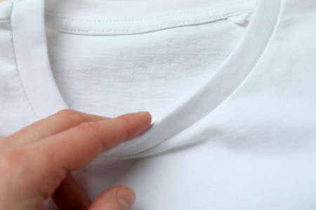 Female hand and white sweatshirt, close up