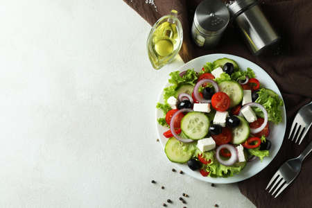 Concept of delicious food with Greek salad on white textured backgroundの写真素材