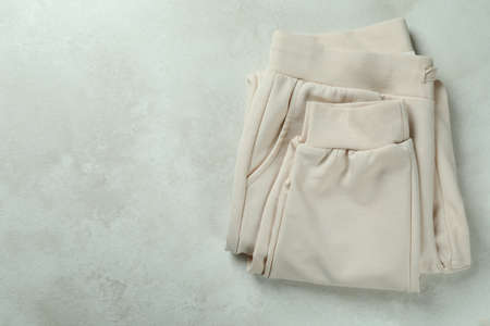 Folded sweatpants on white textured background, space for textの写真素材