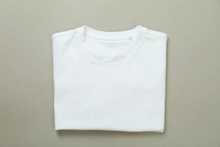 Folded sweatshirt on gray background, space for text