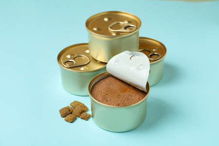 Canned food for pets on blue background, close up